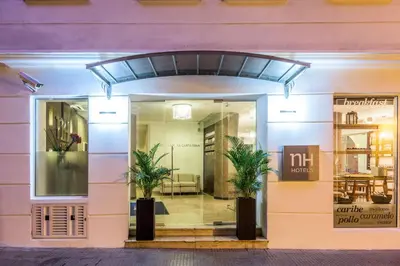 a store front with two palm trees in the doorway at NH Royal Urban Cartagena in Cartagena de Indias