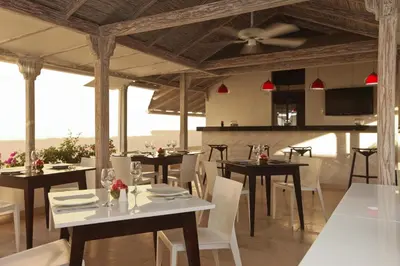 a restaurant with tables and chairs and a ceiling at Zalmedina Hotel in Cartagena de Indias