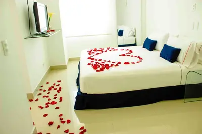a bedroom with a bed with red roses on the floor at Zalmedina Hotel in Cartagena de Indias