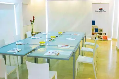 a blue table with white chairs in a room at Zalmedina Hotel in Cartagena de Indias