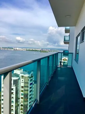a balcony of a building with a view of the ocean at luxuriuso apartament in Cartagena de Indias
