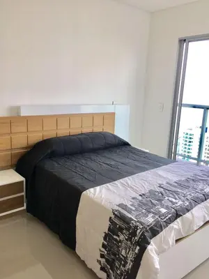 a bedroom with a large bed with a large window at luxuriuso apartament in Cartagena de Indias