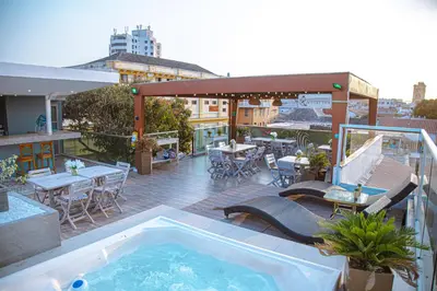 a rooftop patio with a swimming pool on a building at Cartagena Royal Hotel Boutique in Cartagena de Indias