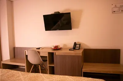a room with a desk and a television on the wall at Cartagena Royal Hotel Boutique in Cartagena de Indias
