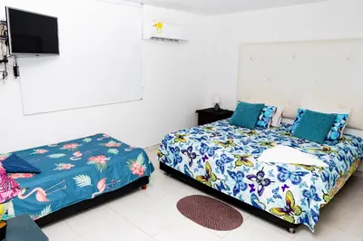 a bedroom with a bed and a tv on the wall at Departamento Bocagrande cerca a playas in Cartagena de Indias