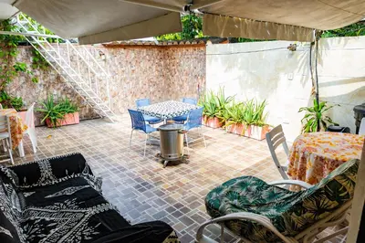 a patio with chairs and a table and a table and chairs at Departamento Bocagrande cerca a playas in Cartagena de Indias