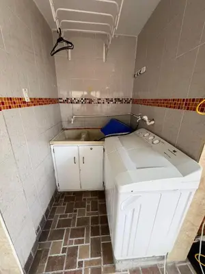a small bathroom with white cabinets and a tile floor at Departamento Bocagrande cerca a playas in Cartagena de Indias