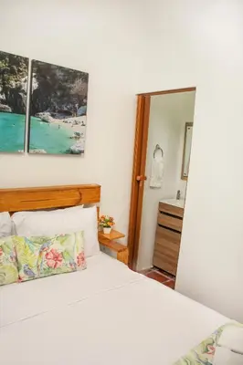 a bedroom with a bed and a mirror at Casa Del Pozo Boutique - Full House in Cartagena de Indias