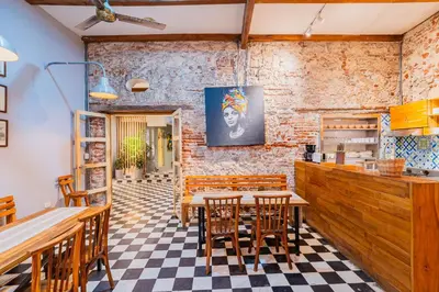 a restaurant with a table and chairs in a room at Casa Del Pozo Boutique - Full House in Cartagena de Indias