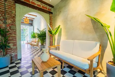 a living room with a white couch and a table at Casa Del Pozo Boutique - Full House in Cartagena de Indias