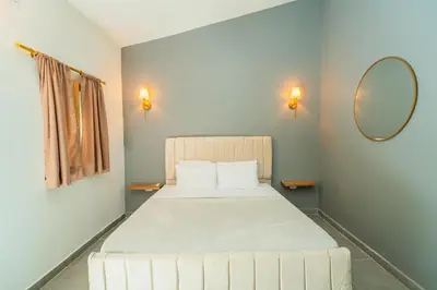 a bedroom with a large white bed with a mirror at Casa Del Pozo Boutique - Full House in Cartagena de Indias