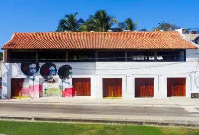 a building with a mural of three women on it at Santuario Getsemani Hostel in Cartagena de Indias