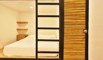 a room with a bed and a book shelf at Santuario Getsemani Hostel in Cartagena de Indias