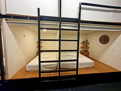 a room with a bunk bed with a ladder at Santuario Getsemani Hostel in Cartagena de Indias