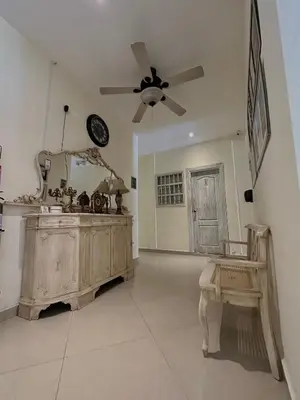 a living room with a ceiling fan and a mirror at Hotel La Magdalena in Cartagena de Indias