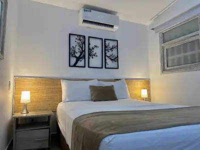 a bedroom with a bed and three pictures on the wall at Hotel La Magdalena in Cartagena de Indias