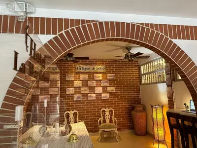 a room with a brick wall and a table and chairs at Hotel La Magdalena in Cartagena de Indias