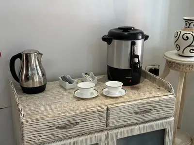 a table with a coffee pot and cups on it at Hotel La Magdalena in Cartagena de Indias