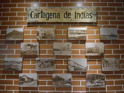 a brick wall with photographs on it with a sign on it at Hotel La Magdalena in Cartagena de Indias