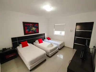 a hotel room with two beds with red pillows at Hotel Or Cartagena in Cartagena de Indias