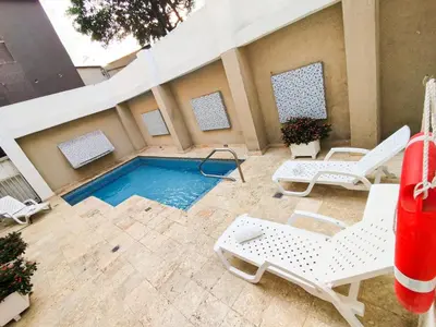 a patio with chairs and a swimming pool at Hotel Or Cartagena in Cartagena de Indias