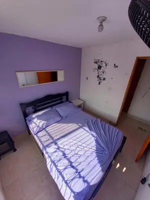 a bedroom with a bed in a purple room at Hostel Shalom Adonai in Cartagena de Indias