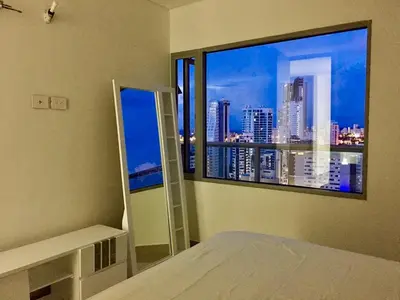a bedroom with a large window with a city view at Luxury Infinitum in Cartagena de Indias