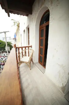 a bench sitting on a porch next to a door at Soy Local Centro Histórico in Cartagena de Indias