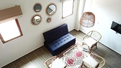 a living room with a blue couch and chairs at Soy Local Centro Histórico in Cartagena de Indias