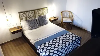 a small bedroom with a bed and a chair at Soy Local Centro Histórico in Cartagena de Indias