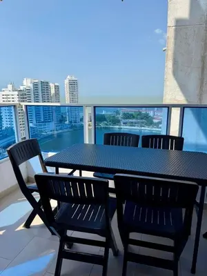 a black table and chairs on a balcony at Palmera Beach in Cartagena de Indias