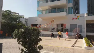 two people walking in front of a building with a kite at Morros Vitri Cartagena in Cartagena de Indias
