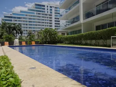 a swimming pool in front of a large building at Morros Vitri Cartagena in Cartagena de Indias