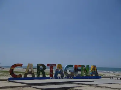 a sign on the beach with the ocean in the background at Morros Vitri Cartagena in Cartagena de Indias