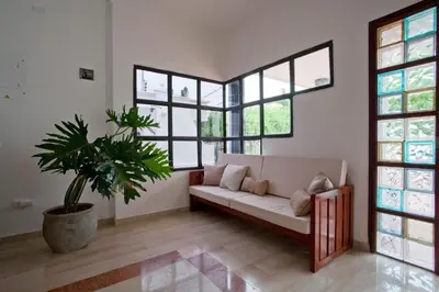 a living room with a couch and a potted plant at Mucura Hotel & Spa in Cartagena de Indias