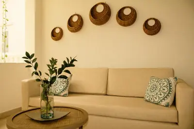 a living room with a couch and a table at Hotel AT THE PARK in Cartagena de Indias