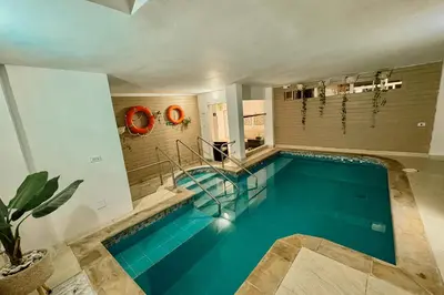 a swimming pool in a house with a swimming pool at Hotel AT THE PARK in Cartagena de Indias