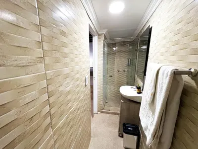 a bathroom with a shower and a sink at Hotel AT THE PARK in Cartagena de Indias