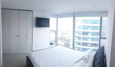 a bedroom with a bed and a large window at Apartamento seaway 935 Morros, La Boquilla in Cartagena de Indias