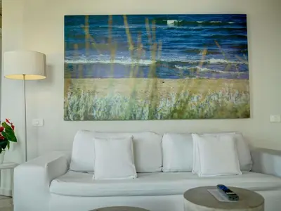 a white couch in a living room with a painting at Hotel Boutique Bovedas de Santa Clara By Accor in Cartagena de Indias
