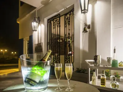 two glasses of wine and a bottle of champagne at Hotel Boutique Bovedas de Santa Clara By Accor in Cartagena de Indias