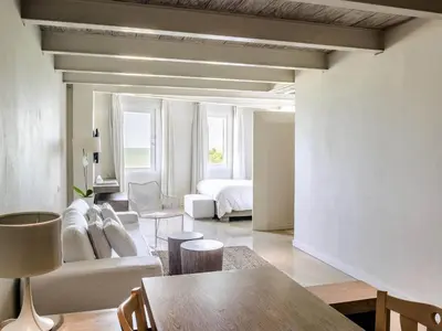 a living room with a couch and a bed at Hotel Boutique Bovedas de Santa Clara By Accor in Cartagena de Indias
