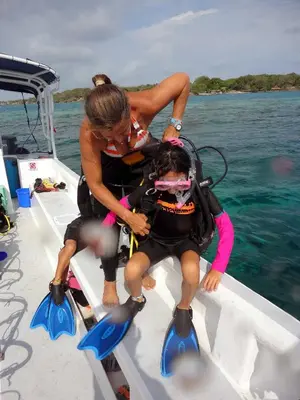 a woman and a child on a boat in the water at Hotel San Pedro de Majagua in Isla Grande