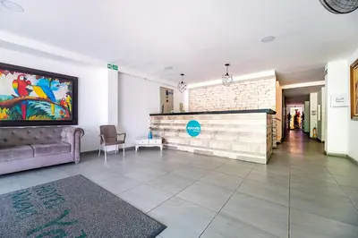 a living room with a couch and a wall at Hotel Nuevo Yalu in Barranquilla