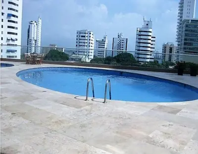 a large blue swimming pool on top of a building at Beach front Apartament in Cartagena de Indias