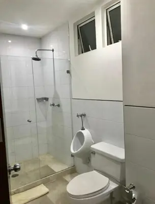 a bathroom with a toilet and a glass shower at Cartagena vista directa al mar amplio apt con terraza privada in Cartagena de Indias