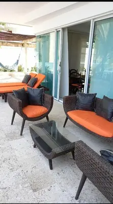 a group of chairs and tables on a patio at Cartagena vista directa al mar amplio apt con terraza privada in Cartagena de Indias