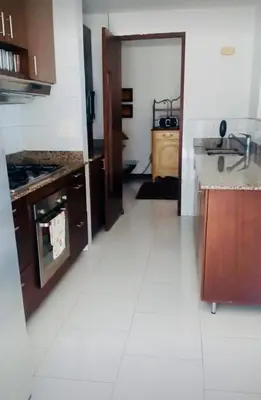 a kitchen with a sink and a stove top oven at Amplio apt de 3 alcobas edificio primera linea de playa in Cartagena de Indias