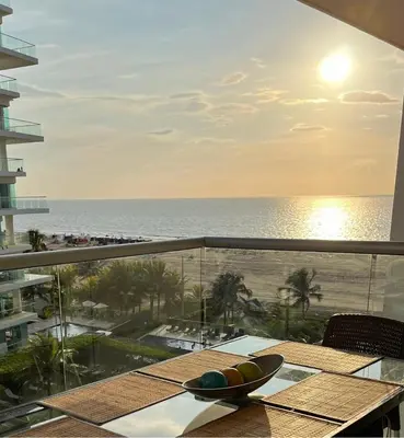 a balcony with a table with a view of the ocean at morros 3 in Cartagena de Indias