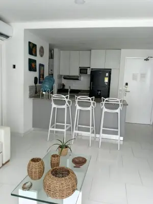 a living room with stools and a table and a kitchen at morros 3 in Cartagena de Indias